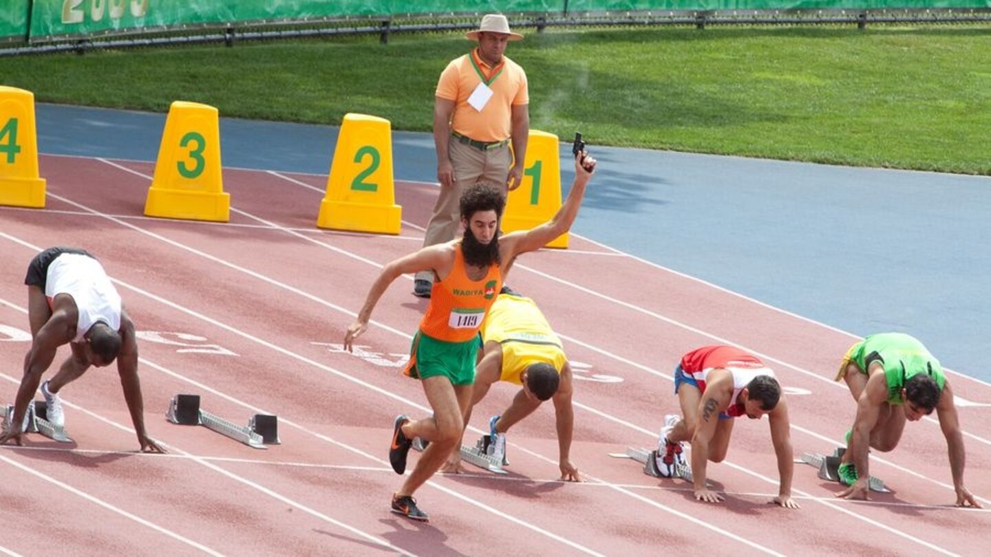 Der DiktatorGleich zu Beginn des Filmes sieht man die Wadiyan Games - olympische Spiele, bei denen es nur einen Gewinner geben kann.