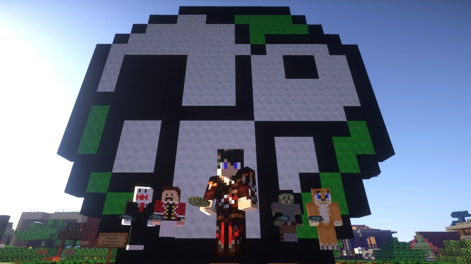 Gruppenbild mit Ugly: Michael Graf (Mitte) und einige Minestar-Einwohner posieren vor dem Maskottchen des GameStar-Forums.