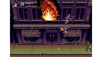 Robin is attacking the holligans while the bank is on fire