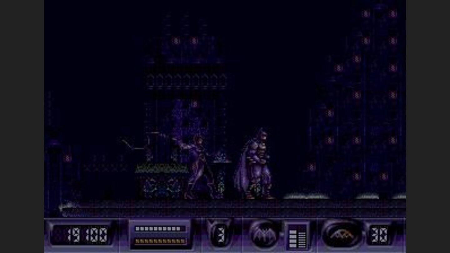 Batman about to be whipped by the Catwoman