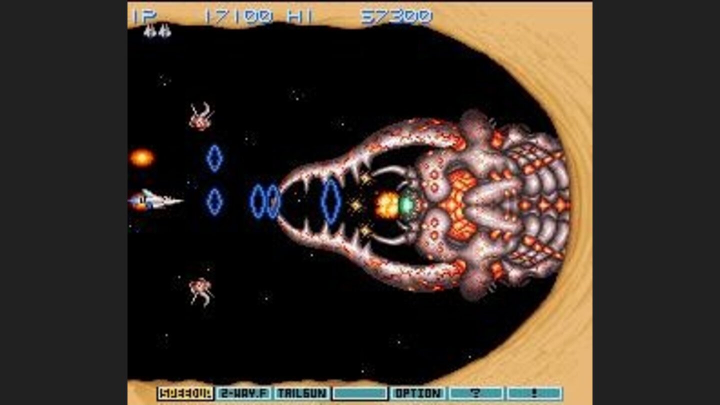 In a cosmic sand field, Vic Viper uses its Ripple Beam to beat the menace called Earwig Scorpion.
