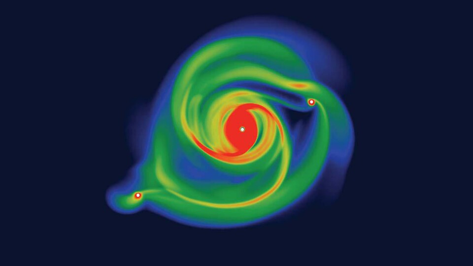 Seht ihr die roten Punkte links und rechts der großen Massescheibe? Das sind die ausbrechenden Klumpen, die sich zu neuen Planeten formen (Quelle: University of Central Lancashire)
