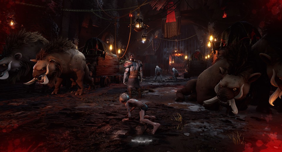 Eine typische Szene aus dem neuen Herr-der-Ringe-Spiel für PC, PS5 und Xbox Series X: Gollum schleicht hinter einer Ork-Wache vorbei, die gerade zwei Sklaven beim Arbeiten zuschaut. Unter den Wägen könnte er sich auch verstecken.