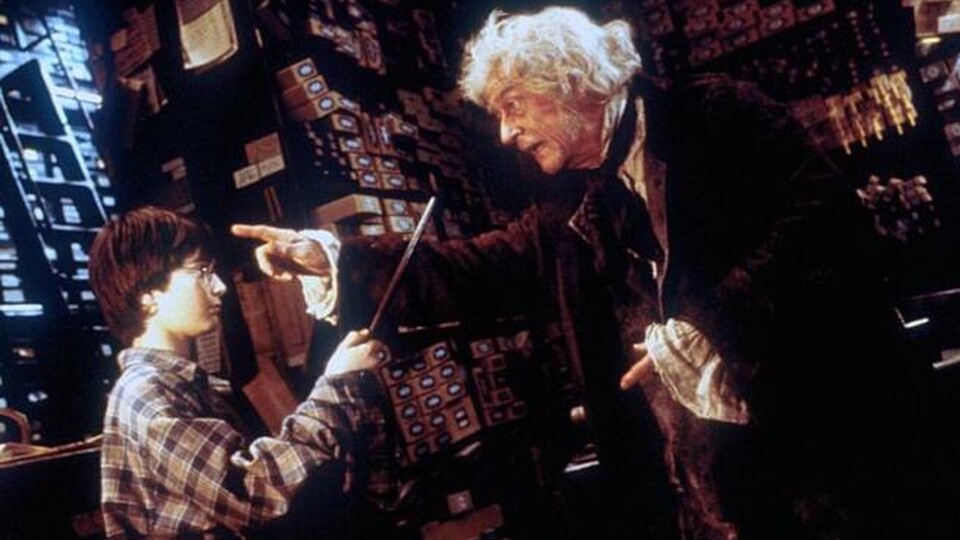 Ollivander (rechts) zeigt Harry, wie es mit dem Zauberstäben läuft. (Foto: Warner Bros.)