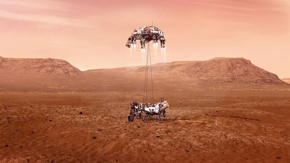 So könnt ihr euch laut der NASA die Landung des Rovers vorstellen. Mit einem Skycrane wurde der Rover 2021 auf der Marsoberfläche abgesetzt und führt seitdem wissenschaftliche Missionen aus. (Symbolbild; Quelle: NASA)