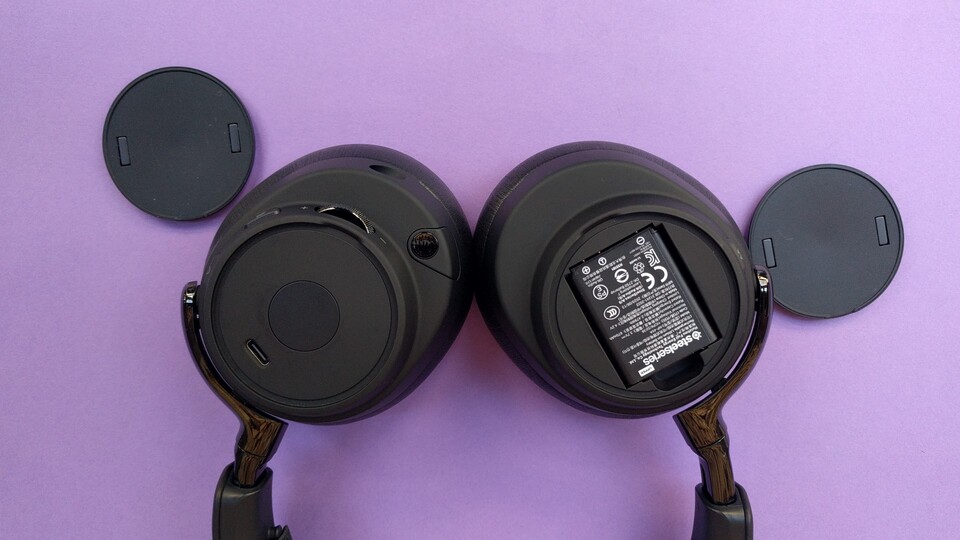 Auf der linken Seite liegt der Ladeanschluss, der optional anstelle der Ladung via Basisstation benutzt werden kann. Auf der rechten Seite ist der Akku. Beide Seiten sind mit einer magnetischen Scheibe abgedeckt. (Bildquelle: Nele WobkerGameStar Tech)