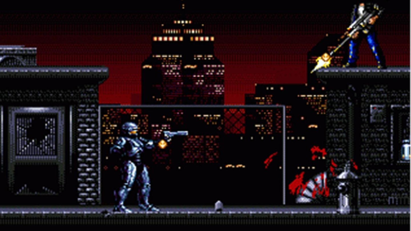 Robocop Versus The Terminator (1994, SEGA Mega Drive)
Ein Multikonsolen-Titel mit gleich zwei Cyborg-Kriegern. Die Story ist in der SNES-Version und der SEGA-Version leicht unterschiedlich, dreht sich aber jeweils darum, dass Robocops Technologie als Grundlage für die fiese KI Skynet diente. Robocop muss sich gegen Terminatoren zur Wehr setzten und gerät trotzdem (Spoiler!) jeweils in eine Falle, in der er von Skynet digitalisiert wird. Irgendwie kann er sich dann später mit Hilfe einer Roboterfabrik wieder zusammensetzen lassen und Skynet in der Zukunft besiegen. Die Geschichte klingt ein bisschen aufgesetzt, zugegeben.